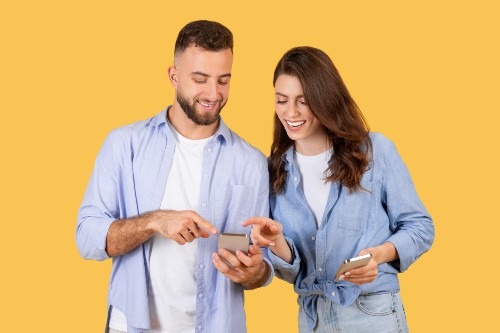 happy-young-couple-sharing-content-on-smartphones-2024-03-08-16-54-27-utc