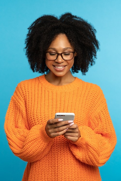 stylish-happy-dark-skinned-millennial-woman-readin-2023-11-27-04-46-16-utc