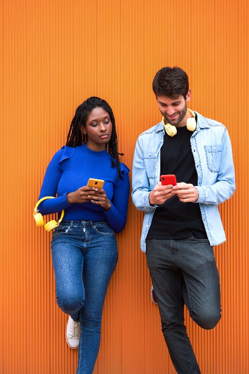 woman-and-man-using-mobile-phone-standing-against-2023-11-27-05-22-03-utc