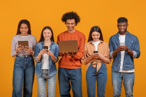 young-peers-using-various-digital-devices-on-orang-2024-04-23-13-26-20-utc